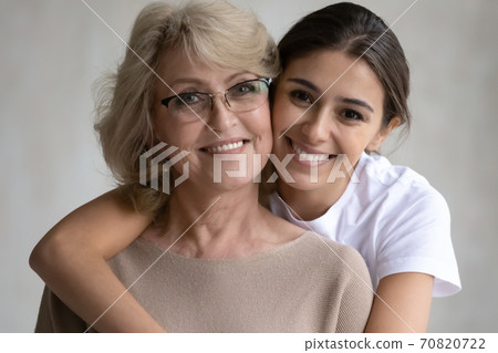 Portrait of happy adult daughter hug senior mom 70820722