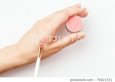 Making a swatch on a female hand of pink lipstick Making a swatch on a female hand of pink lipstick 70821551
