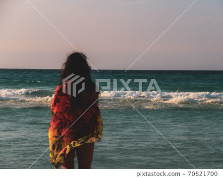 Woman walking on the  white sandy beach and turquoise water in Caribbean Beach in Tulum, Mexico 70821700