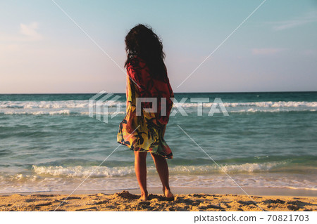 Woman walking on the  white sandy beach and turquoise water in Caribbean Beach in Tulum, Mexico 70821703
