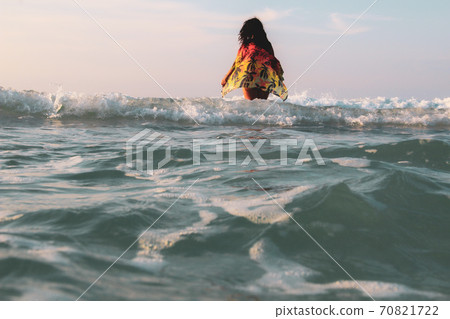 Woman walking on the  white sandy beach and turquoise water in Caribbean Beach in Tulum, Mexico 70821722