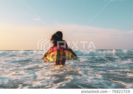Woman walking on the  white sandy beach and turquoise water in Caribbean Beach in Tulum, Mexico 70821729