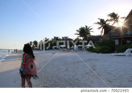 girl walking on white sandy beach of caribbean at sunset in Tulum, Mexico girl walking on white sandy beach of caribbean at sunset in Tulum, Mexico 70822493