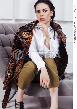 pretty stylish woman in fashion dress with in luxury rich room interior, lifestyle people concept, modern brunette 70825152