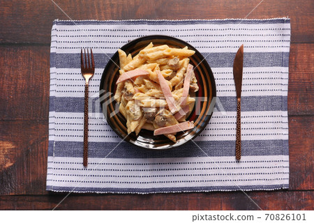 homemade cooked pasta in a plate on table . homemade cooked pasta in a plate on table . 70826101