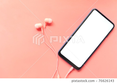smart phone with empty screen, earphone on pink background smart phone with empty screen, earphone on pink background 70826143