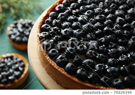 Concept of tasty lunch with blueberry pie on green background Concept of tasty lunch with blueberry pie on green background 70826394