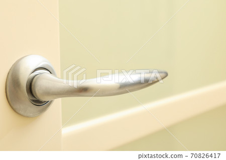Metal handle of white door in room Metal handle of white door in room 70826417