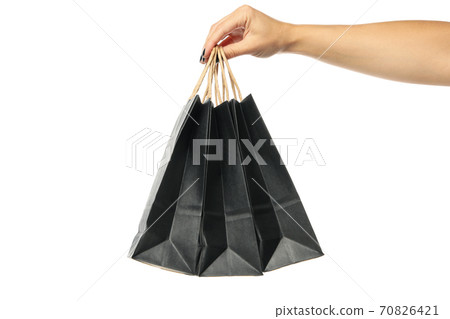 Female hand hold paper bags, isolated on white background Female hand hold paper bags, isolated on white background 70826421