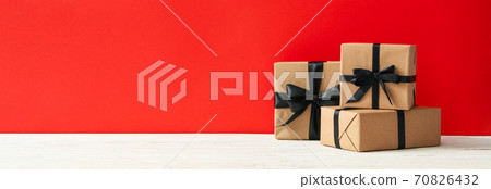 Gift boxes on red background, space for text Gift boxes on red background, space for text 70826432