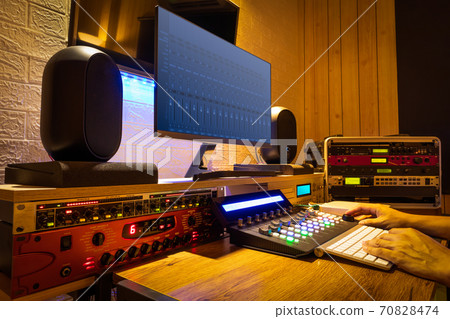 sound engineer hands working on digital professional audio equipment in recording, editing, broadcasting studio 70828474