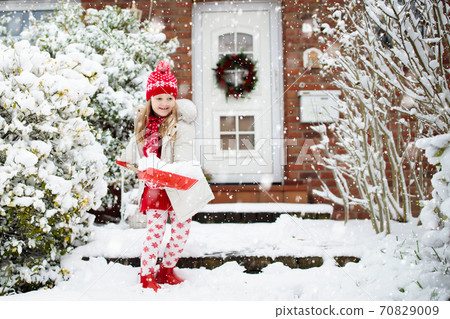 Child shoveling winter snow. Kids clear driveway. Child shoveling winter snow. Kids clear driveway. 70829009