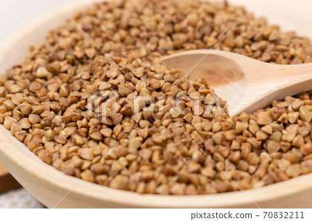 Buckwheat grain dry buckwheat. Close-up of brown buckwheat groats. Healthy food. Buckwheat grain dry buckwheat. Close-up of brown buckwheat groats. Healthy food. 70832211