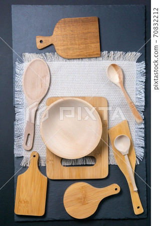 wooden cutlery large wooden Spoon and chopping boards on a black background. vertical photo wooden cutlery large wooden Spoon and chopping boards on a black background. vertical photo 70832212