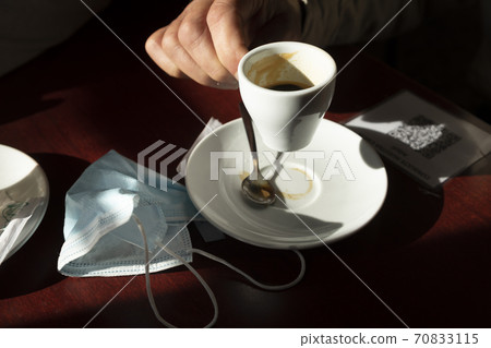 The hand of a man, holds a cup of coffee, Spain The hand of a man, holds a cup of coffee, Spain 70833115