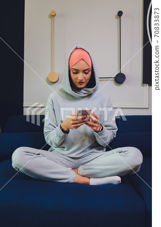Portrait of a beautiful, elegant and attractive young Malay Asian Muslim woman in a dress and an hijab head scarf. Portrait of a beautiful, elegant and attractive young Malay Asian Muslim woman in a dress and an hijab head scarf. 70833873