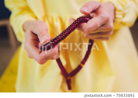 Muslim woman in hijab praying on mat indoors. Muslim woman in hijab praying on mat indoors. 70833891