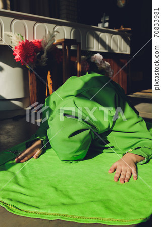 Muslim woman in hijab praying on mat indoors. Muslim woman in hijab praying on mat indoors. 70833981