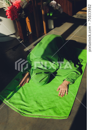 Muslim woman in hijab praying on mat indoors. Muslim woman in hijab praying on mat indoors. 70833982