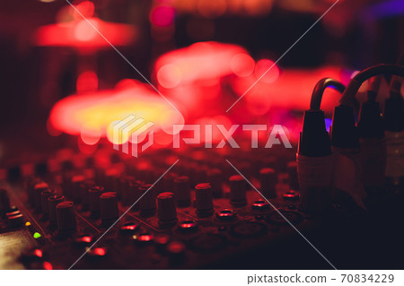 Audio and video jack cable connected at rear end of receiver, amplifier or music mixer at concert, party or festival. Soft effect on photo. 70834229