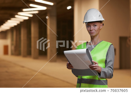 Woman Holding Clipboard at Construction Site Indoors 70837605