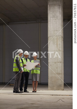 Inspection Committee Discussing Plans at Construction Site Inspection Committee Discussing Plans at Construction Site 70837611