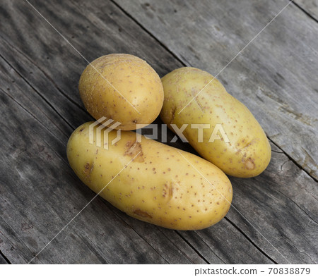 Top view of patato isolated on wooden taber background 70838879