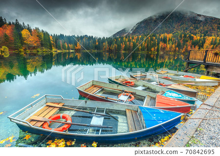 Amazing autumn landscape and colorful boats, Lake Fusine, Italy, Europe 70842695