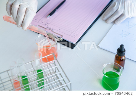 Scientist wear lab coat and protective wear are working with research or doing investigations with test tubes in experiment, Laboratory and development concept Scientist wear lab coat and protective wear are working with research or doing investigations with test tubes in experiment, Laboratory and development concept 70843462