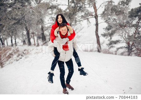 Loving couple walking in a winter park 70844183