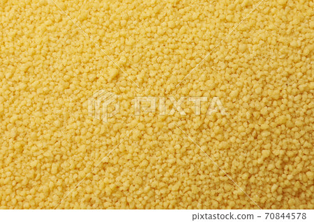 Raw couscous on whole background, close up 70844578