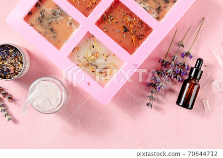 Handmade soap, the process of making. Glycerin with herbs, poured into a special mold for drying, shot from above Handmade soap, the process of making. Glycerin with herbs, poured into a special mold for drying, shot from above 70844712