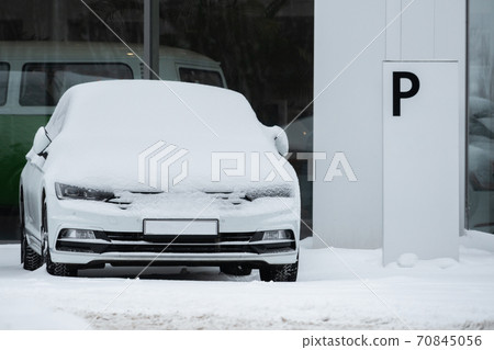 Parked cars covered with snow 70845056