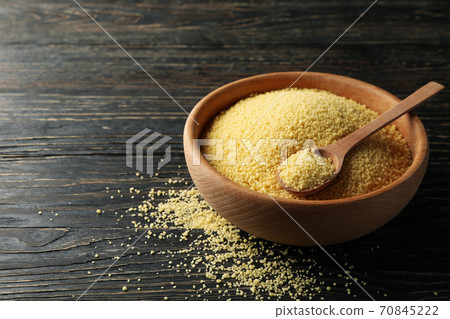 Bowl with couscous and spoon on wooden background Bowl with couscous and spoon on wooden background 70845222