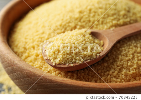 Bowl with couscous and spoon on wooden background Bowl with couscous and spoon on wooden background 70845223