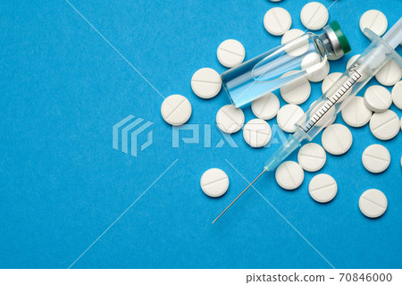 Top view of Pills, Syringe And Ampoule With Vaccination On blue background with copy space 70846000