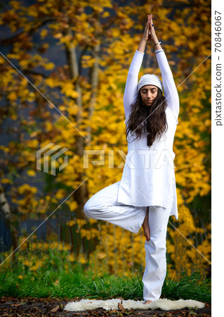 Young woman during a yoga practice in the autumn nature 70846067