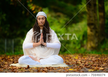 Yoga practice in the autumn park by a girl 70846074