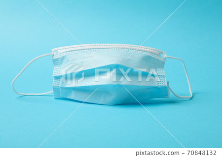 Medical mask on blue background, space for text Medical mask on blue background, space for text 70848132