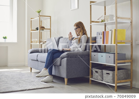 Online work or remote education. Serious young woman studying or conducting web business conference at home 70849009