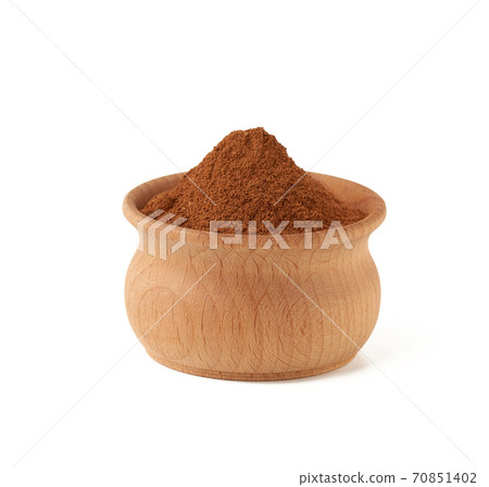 ground cinnamon in a wooden bowl isolated on white background 70851402