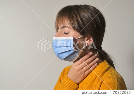 Woman Wearing Medical Mask and Throat Pain 70852083