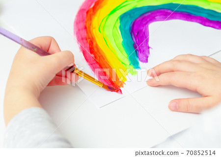 Child's hands drawing rainbow. 70852514