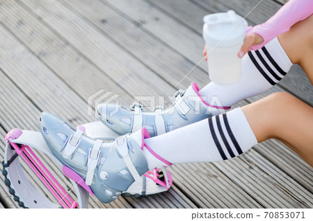 Close ups womans feet with kangoo jumps. Outdoor city sport and training. 70853071