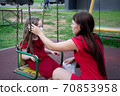 Child and mom in medical mask on a walk. Family wearing face mask 70853958