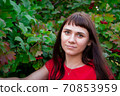 portrait of a young woman in red clothes	 70853959
