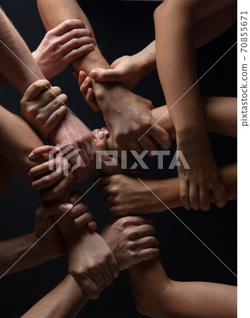 Hands of people's crowd in touch isolated on black studio background. Concept of human relation, community, togetherness, symbolism Hands of people's crowd in touch isolated on black studio background. Concept of human relation, community, togetherness, symbolism 70855671