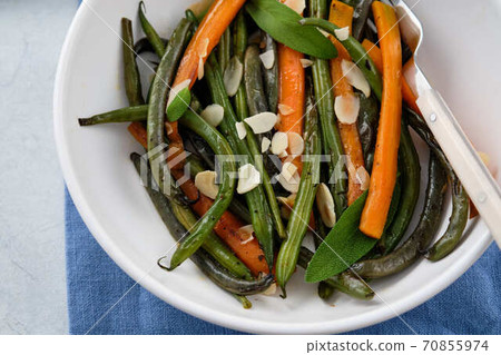 Green beans with carrots cooked with olive oil and sage. Healthy food. 70855974