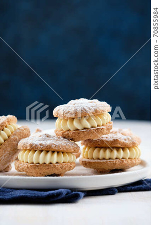 Delicious hazelnut shortbread sandwiches filled with vanila cream. Christmas recipe. Delicious hazelnut shortbread sandwiches filled with vanila cream. Christmas recipe. 70855984