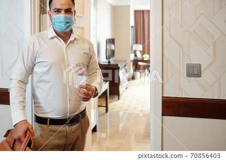 Guest standing in hotel room Guest standing in hotel room 70856403